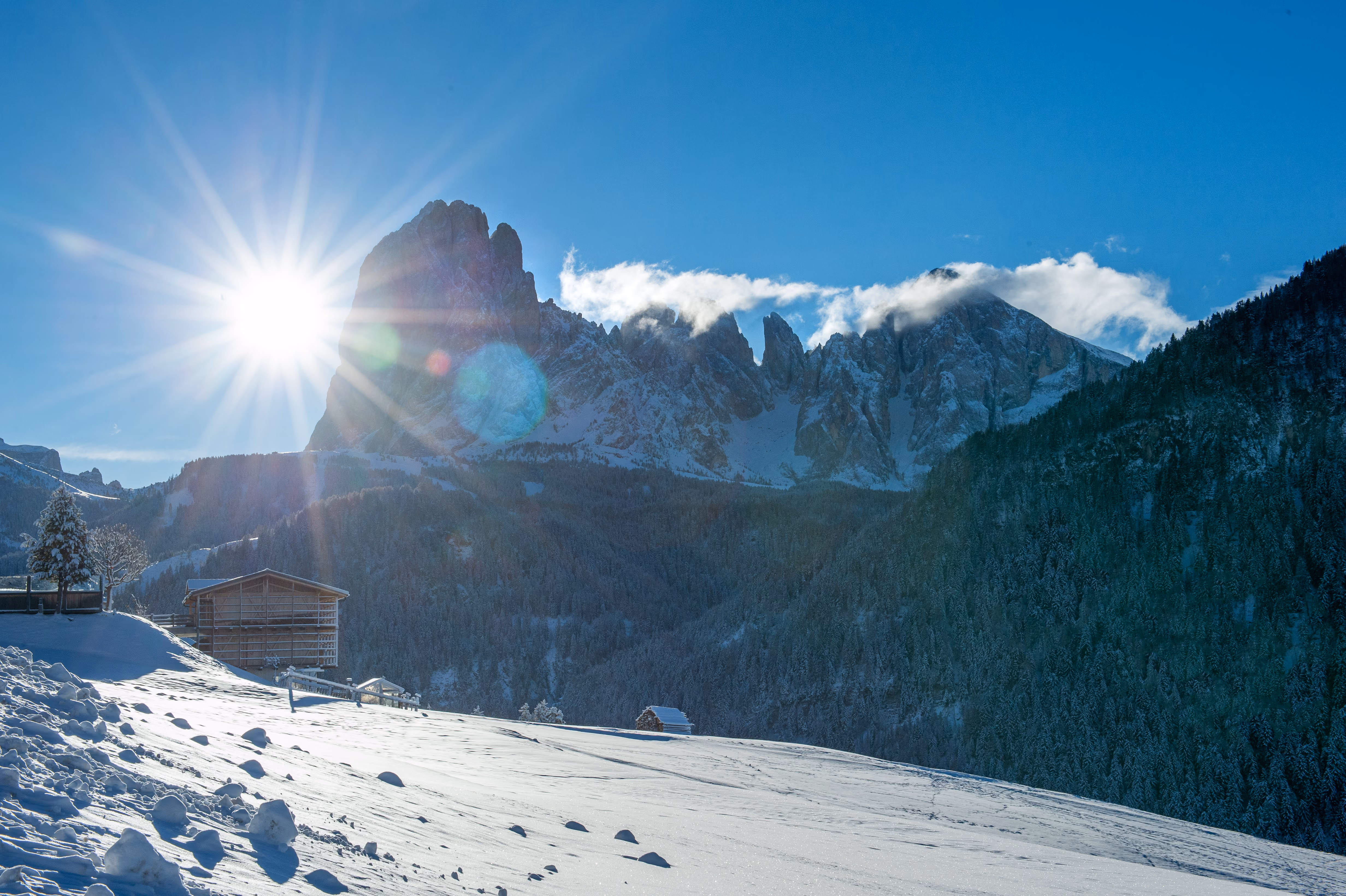 Winter: low sun over Sassolungo, the hay barn below the garden